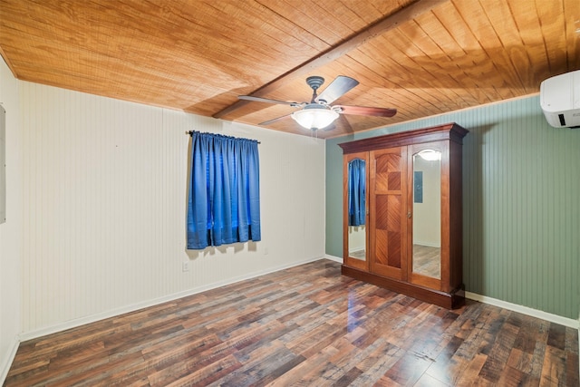 spare room featuring wood-type flooring, ceiling fan, wooden ceiling, a wall mounted air conditioner, and baseboards