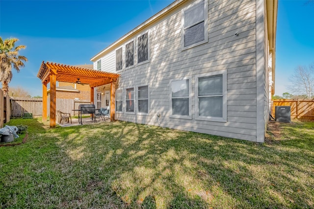 rear view of property featuring a lawn, a patio, a fenced backyard, cooling unit, and a pergola