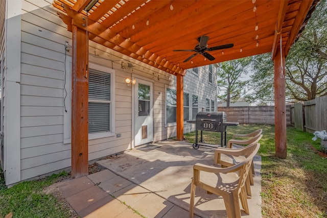 view of patio / terrace with a ceiling fan, a fenced backyard, and grilling area