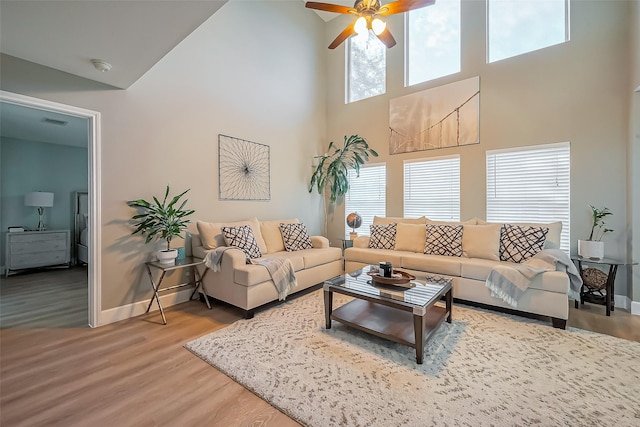 9314 Dune Gate Ct, Humble, TX 77396 - living area featuring a high ceiling, ceiling fan, and wood finished floors