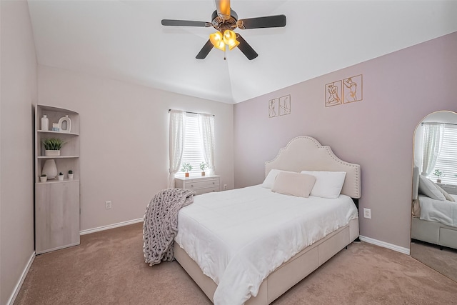 carpeted bedroom with vaulted ceiling, multiple windows, and baseboards