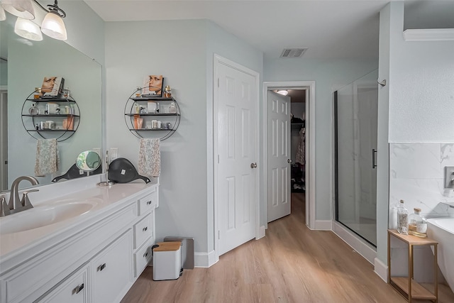9314 Dune Gate Ct, Humble, TX 77396 - bathroom with vanity, wood finished floors, a shower stall, and a bathtub