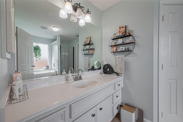 bathroom featuring a stall shower, a bath, and vanity