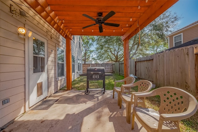 view of patio with a fenced backyard, a ceiling fan, and area for grilling