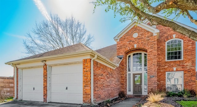 9314 Dune Gate Ct, Humble, TX 77396 - view of front of property featuring brick siding, roof with shingles, an attached garage, and driveway