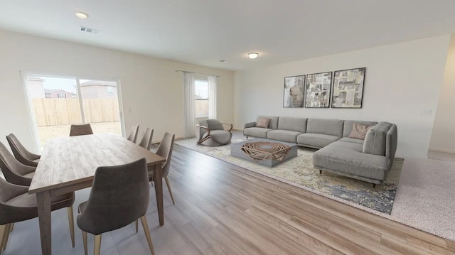 living area with wood finished floors and visible vents