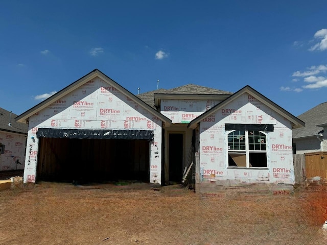 unfinished property with an attached garage