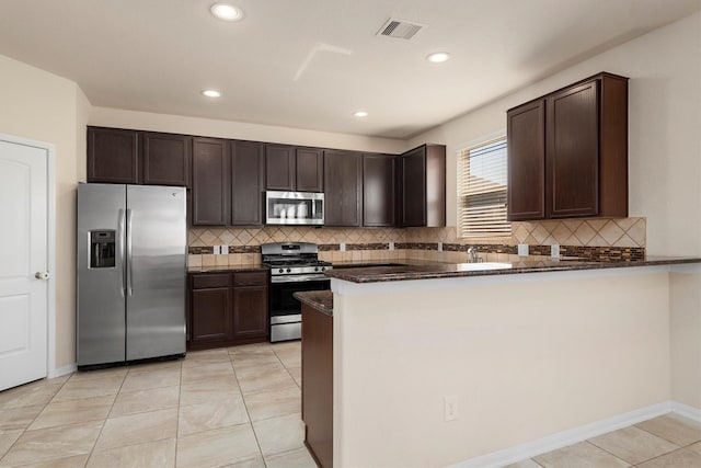 kitchen featuring dark brown cabinetry, visible vents, and stainless steel appliances