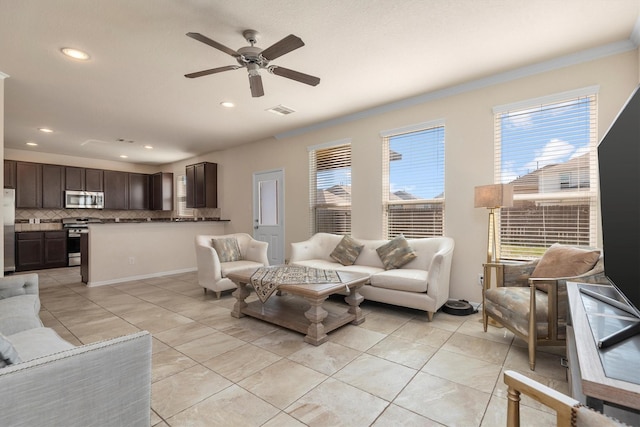 living area featuring a wealth of natural light, visible vents, ceiling fan, and recessed lighting