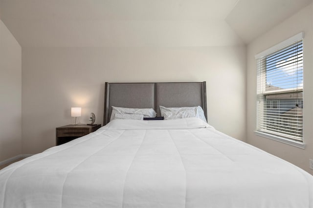 bedroom featuring lofted ceiling