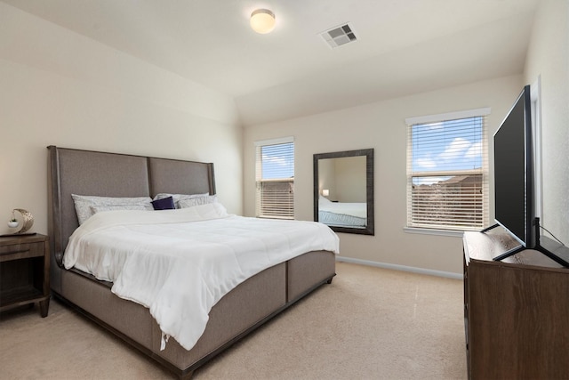 bedroom with baseboards, visible vents, vaulted ceiling, and light colored carpet