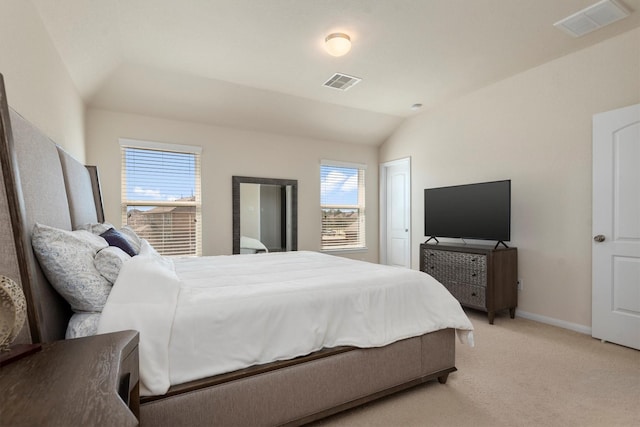 bedroom featuring lofted ceiling, visible vents, light carpet, and baseboards