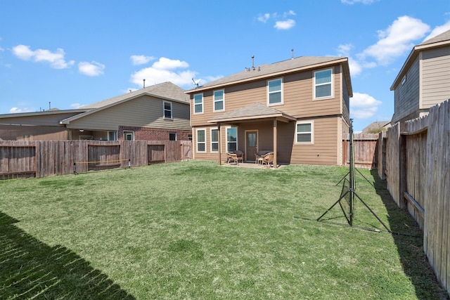 rear view of property with a fenced backyard, a patio, and a lawn