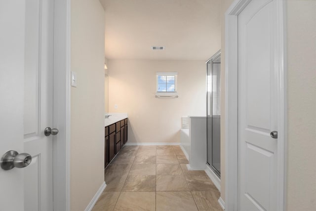 bathroom with a garden tub, visible vents, an enclosed shower, vanity, and baseboards