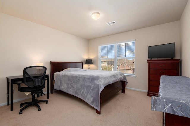 carpeted bedroom with visible vents and baseboards