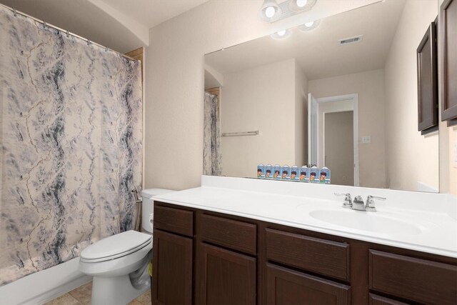 bathroom with visible vents, vanity, toilet, and tile patterned floors