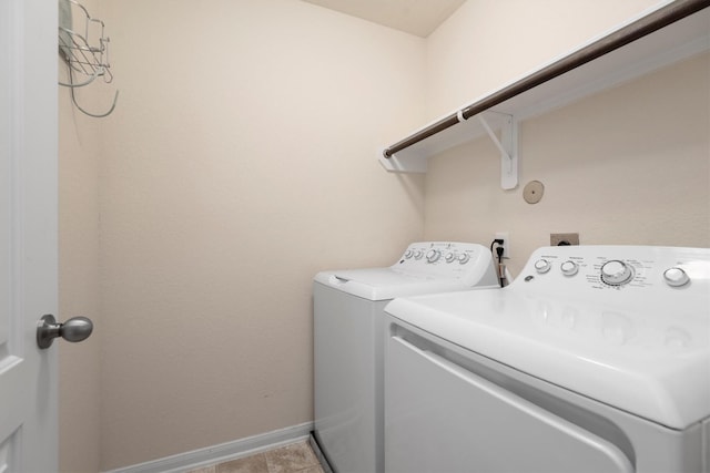 clothes washing area featuring laundry area, independent washer and dryer, baseboards, and light tile patterned floors