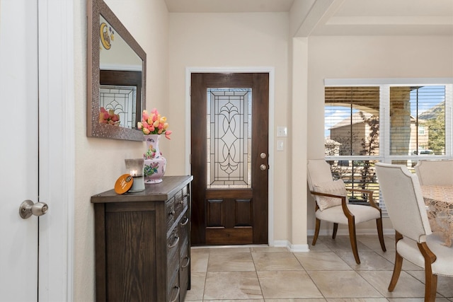 entrance foyer featuring baseboards and light tile patterned flooring