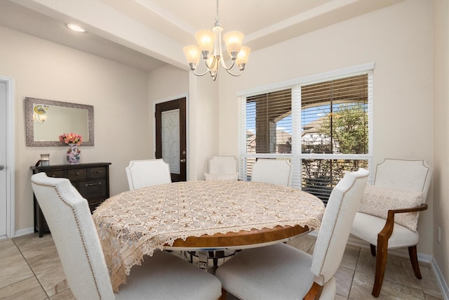 dining area featuring baseboards and a notable chandelier