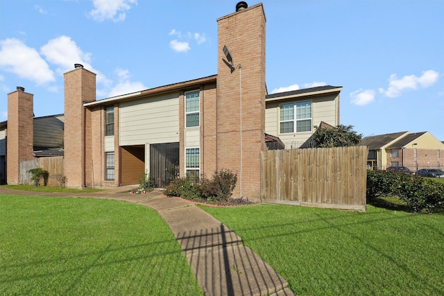 exterior space with a chimney, fence, and a lawn