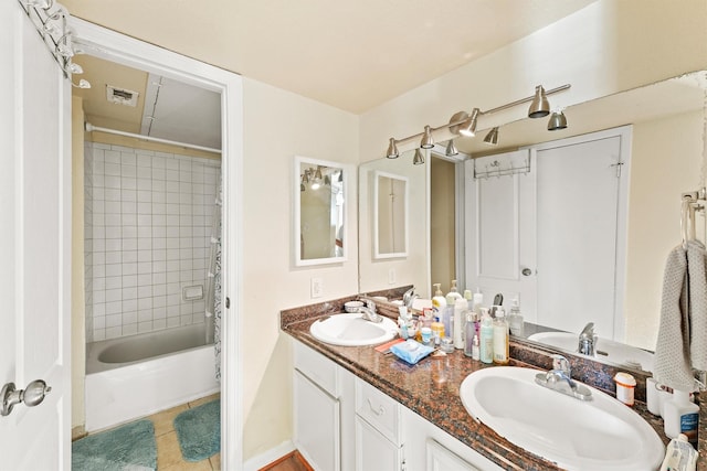 full bathroom featuring tile patterned flooring, visible vents, a sink, and double vanity