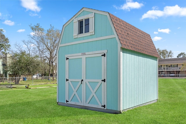 view of shed featuring fence