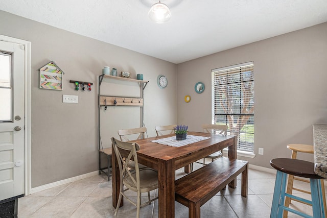 dining room featuring light tile patterned flooring and baseboards