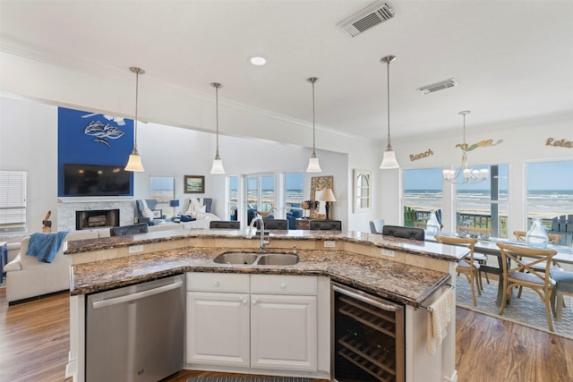 kitchen featuring wine cooler, visible vents, open floor plan, and dishwasher