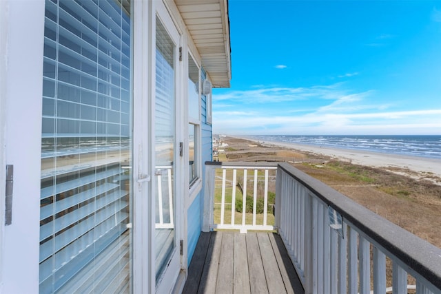 balcony with a water view and a beach view