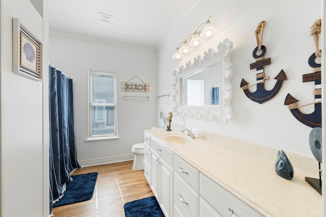 full bath featuring toilet, wood finished floors, vanity, baseboards, and crown molding