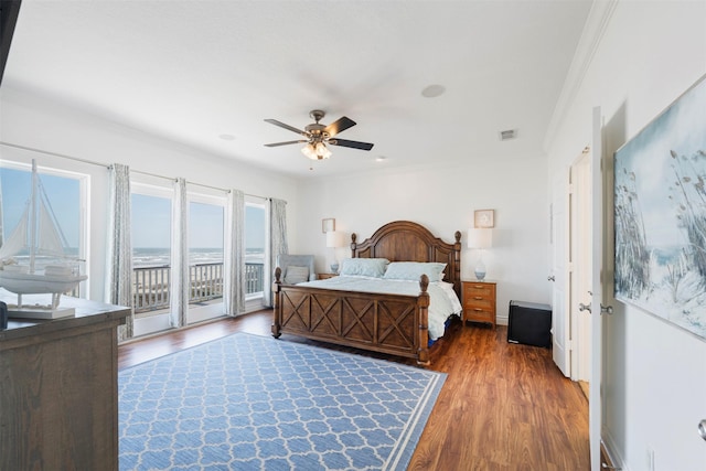 bedroom with access to exterior, crown molding, visible vents, a ceiling fan, and wood finished floors