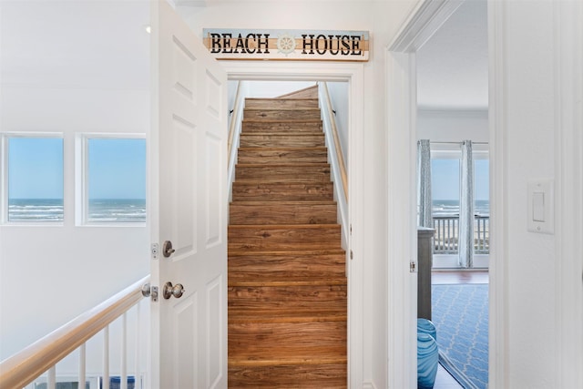 corridor with stairs and a water view