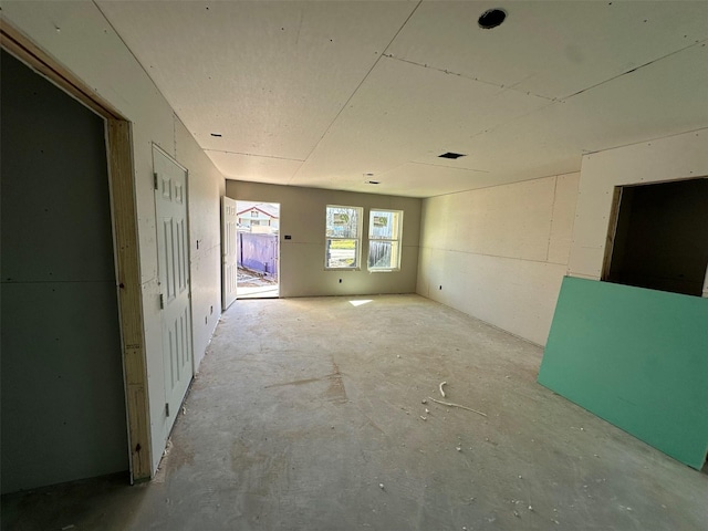 unfurnished room featuring concrete floors