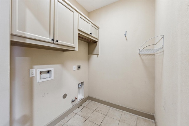 clothes washing area featuring light tile patterned floors, cabinet space, gas dryer hookup, hookup for a washing machine, and hookup for an electric dryer