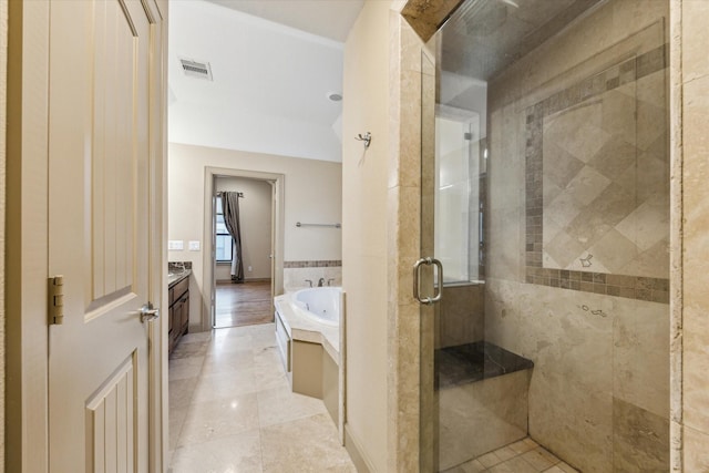 full bathroom featuring visible vents, tile patterned flooring, vanity, a shower stall, and a bath