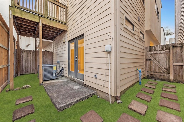 view of patio / terrace featuring a fenced backyard, central AC, and french doors