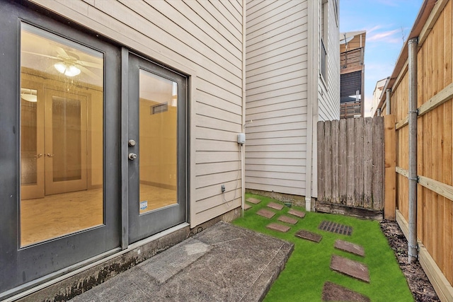 doorway to property featuring a yard and fence