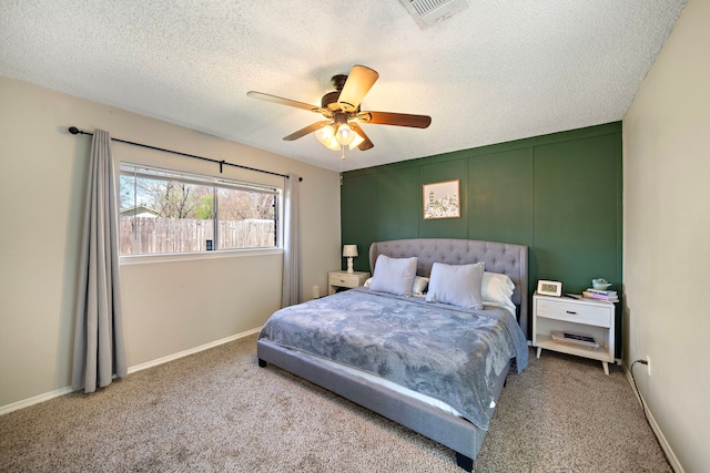 bedroom featuring baseboards, carpet, visible vents, and a textured ceiling