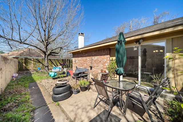 view of patio with outdoor dining area and a fenced backyard