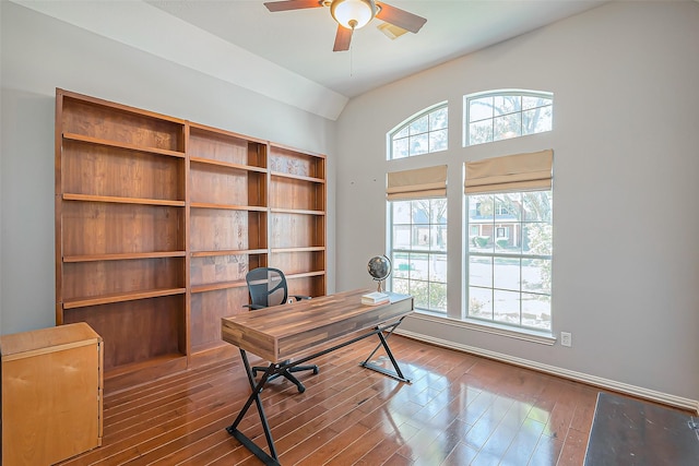 office featuring a ceiling fan, lofted ceiling, and dark wood-style flooring