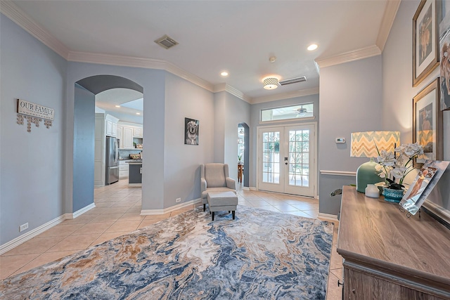 sitting room with light tile patterned floors, visible vents, french doors, and ornamental molding