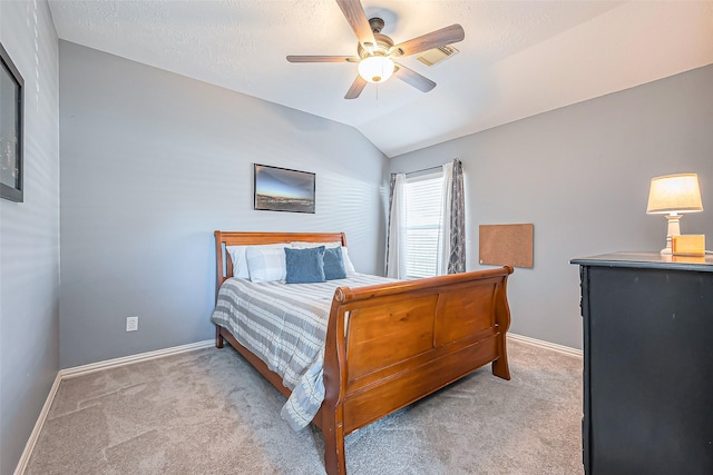 carpeted bedroom featuring a ceiling fan, visible vents, vaulted ceiling, and baseboards