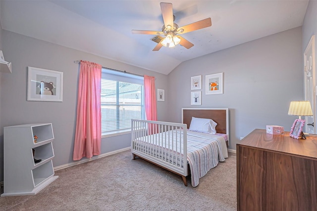 bedroom with vaulted ceiling, light carpet, a ceiling fan, and baseboards