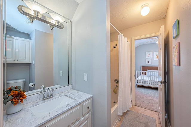 bathroom featuring a textured ceiling, tile patterned flooring, toilet, vanity, and shower / bath combo