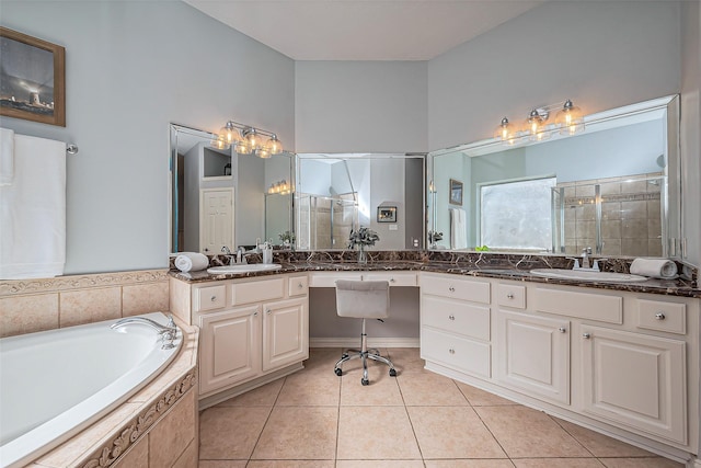 full bath with a stall shower, a sink, and tile patterned floors