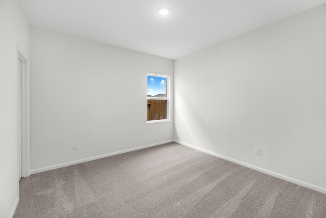 empty room with carpet floors and baseboards