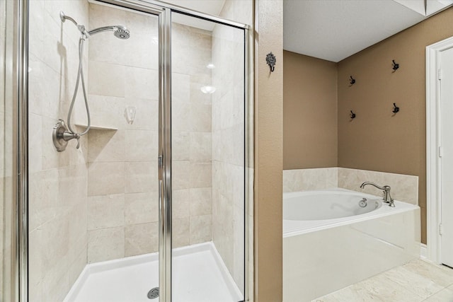 bathroom featuring a stall shower and a garden tub