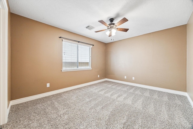 carpeted empty room with a ceiling fan, visible vents, and baseboards