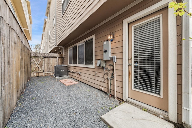 exterior space with cooling unit, fence, and a patio