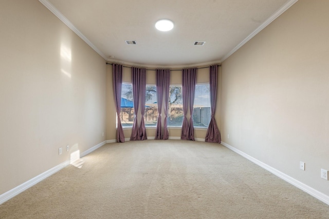 unfurnished room with ornamental molding, light colored carpet, visible vents, and baseboards